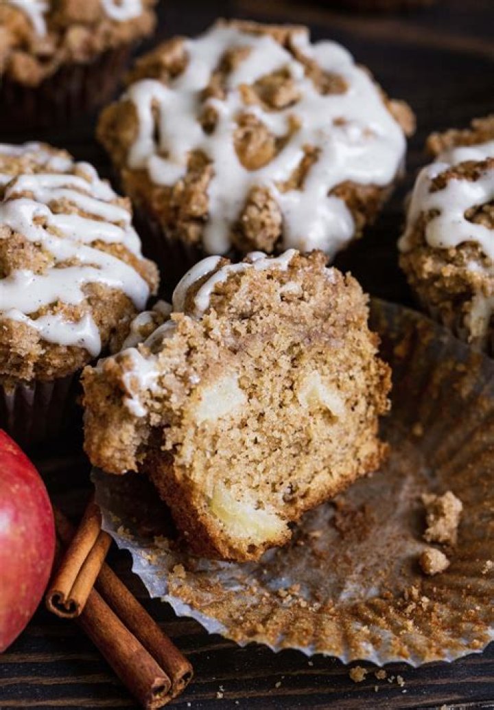 Apple cinnamon muffin cut in half and topped with butter.