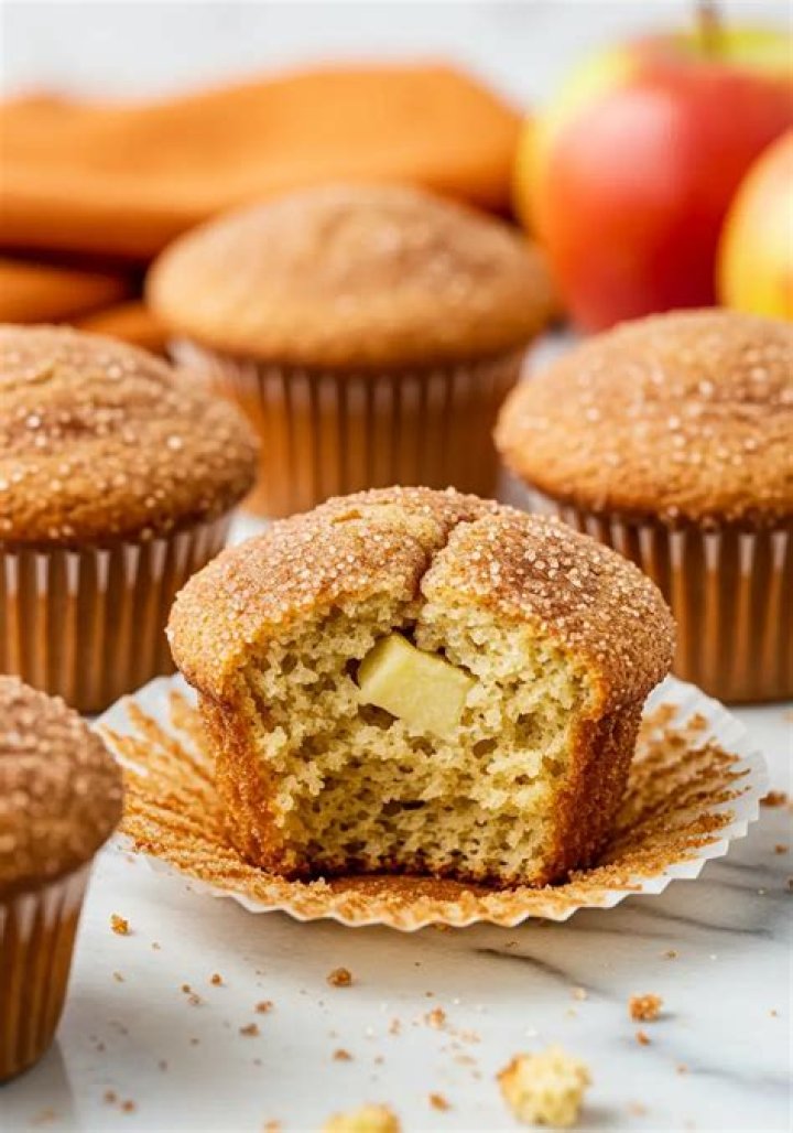 Apple cinnamon muffins on a wire rack topped with a cinnamon icing drizzle.