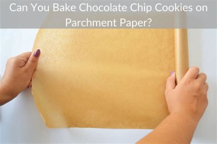 Chocolate chip cookies on parchment paper.