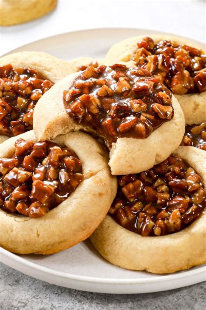 Pecan pie cookie with a bite taken out of it.